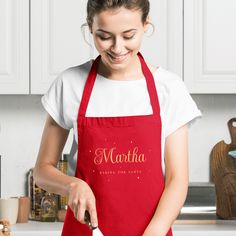 a woman in an apron is cutting some food on a board with a spatula