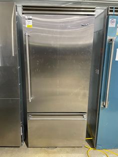 two stainless steel refrigerators are next to each other