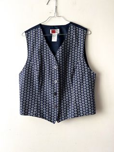 "Vintage Women's summer vest Blue white Patterned viscose Vest Button Up Waistcoat Hippie Festival Vest Size Medium Retro vest 90s lady vest Label size: D/NL 38; B/F 40; GB 12 Estimated size: M Measurements (lying flat): Length: 19.5\"/ 49.5 cm Pit to pit: 19.5\"/ 49.5 cm Waist: 18.5\"/ 47 cm Please check measurements to insure a proper fit. Remember to allow yourself some extra room for movement. You can compare these with something from your closet that fits you well. This vest will come to you freshly laundered and ready to wear. Please convo me if you need additional measurements. Condition: great Vintage Condition SHIPPING * I ship worldwide via Priority mail (Latvijas Pasts) from Latvia (EU). * I ship from Europe, so please allow 2 to 4 weeks for the package to arrive if you live ove Blue Button-up Vest For Spring, Blue Button-up Vest With Buttons, Fitted Summer Vest With Buttons, Blue Button-up Vest With Button Closure, Blue Button-up Vest, Blue Vest With Button Closure For Spring, Retro Fitted Vest For Summer, Retro Fitted Summer Vest, Classic Button-up Summer Vest