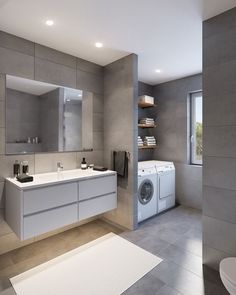 a bathroom with a washer and dryer next to a window in the wall