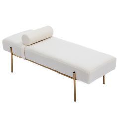 a white couch sitting on top of a metal frame