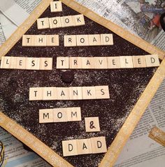 scrabble tiles spelling out the words i took the road less traveled, thanks mom and dad