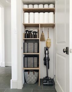 the shelves in this bathroom are filled with cleaning supplies