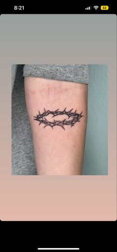 a black and white photo of a woman's thigh with barbed wire on it