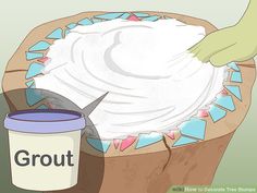 a bucket filled with white frosting next to a can of blue and green paint