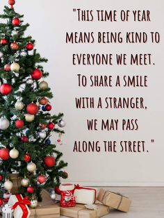 a christmas tree with presents under it and a quote on the wall behind it that says, this time of year means being kind to everyone we meet