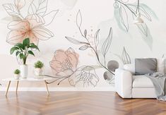 a white couch sitting next to a wooden table on top of a hard wood floor