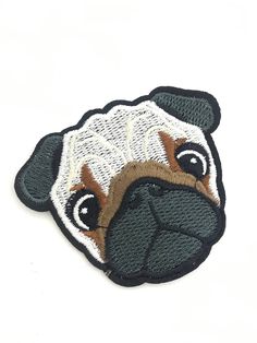 a pug dog embroidered patch on a white background