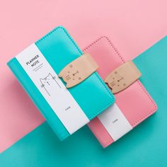 a pink, blue and white case with two clips attached to it on a pastel colored background