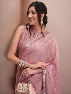 Pink and silver-toned sareeStriped embroidered saree with embroidered border borderHas sequinned detailThe saree comes with an unstitched blouse pieceThe blouse worn by the model might be for modelling purpose only. Check the image of the blouse piece to understand how the actual blouse piece looks like. Saree Sale, Embroidered Saree, Embroidered Border, Ethnic Dress, Organza Saree, Teal And Gold, Blue Paisley, Georgette Sarees, The Model