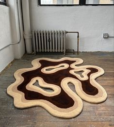 an area rug is shown in front of a radiator and heater on the floor