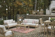 an outdoor living area with furniture and tables