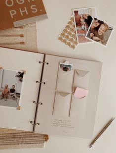 an open photo book with photos on the pages and some other things to do around it