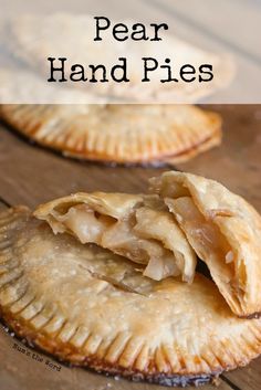 two homemade hand pies sitting on top of a wooden table