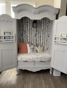 a white bed sitting in the middle of a room