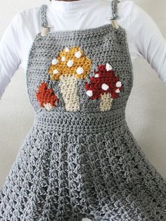 a crocheted apron with mushrooms on it