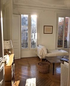 an empty living room with wood floors and white walls is pictured in this image from the doorway