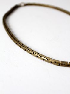 This is a vintage brass chain link necklace.  Square notched links slither together to shape the necklace with a spring ring clasp.  CONDITION In good condition with a nice patina to the brass.  MEASUREMENTS Length:  21"  ..  53.3 cm Width:  0.25"  ..  0.6 cm 91806 Vintage Bronze Brass Chain Necklace, Vintage Antique Gold Brass Chain Necklace, Vintage Brass Chain Necklace In Antique Gold, Vintage Brass Link Necklace, Vintage Box Chain Necklace, Vintage Metal Chain Necklace With Lobster Clasp, Vintage Oval Link Box Chain Necklace, Vintage Box Chain Link Necklace, Vintage Metal Snake Chain Necklace