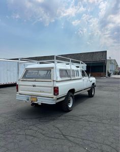 a white pick up truck parked in a parking lot