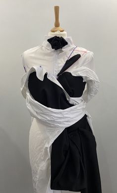 a mannequin is dressed in white and black