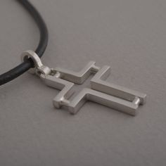 Minimal line and ingenious design characterize this beautiful sterling silver cross pendant necklace for men or women. The effect is minimalistic, yet alluring. Suspended from a silver chain or leather cord with silver clasp and endings, it is a stylish accessory for anyone that wants to keep their faith close to their heart and share it for the world to see. This also makes a stunning Christian gift for a special person in your life. Cross measures 3.8 cm x 2 cm. You get the cross with a 48 cm Modern Cross Pendant Necklaces As Gift, Modern Necklaces With Cross Pendant For Gift, Modern Necklaces With Cross Pendant As Gift, Modern Crucifix Cross Necklace As Gift, Minimalist Adjustable Cross Pendant Necklace, Adjustable Minimalist Cross Necklace, Modern Crucifix Necklace As Gift, Modern Cross Necklace As A Gift, Modern Silver Cross Pendant Necklace