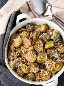 a white bowl filled with brussel sprouts covered in powdered sugar