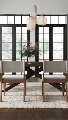 a dining room table with four chairs and two lamps hanging from the ceiling over it