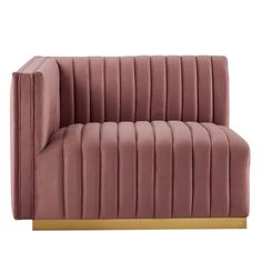 a pink velvet couch with gold legs and arm rests on an isolated white background,