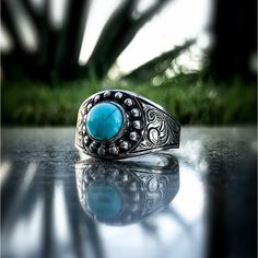 Rockin Out Jewelry’s “Posie” is a solid sterling silver ring that features an 8mm round GENUINE KINGMAN TURQUOISE STONE in the center surrounded by an oval beaded border. It’s about 12mm wide in the front and tapers in the back for a comfy, all day wear fit. The sides showcase beautiful western style engraving done by The Master, Justin Walker. Available in sizes 5-13 including half sizes. The “Posie” is a durable heavy duty ring that can be worn on any occasion. Southwestern Style Engraved Round Rings, Southwestern Engraved Round Rings, Silver Western Rings, Justin Walker, Western Rings, Kingman Turquoise, Men's Rings, Turquoise Stone, Western Style