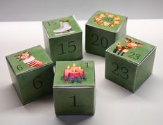 four green cubes with numbers and pictures on them