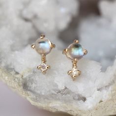 These earrings are the sweetest! Handcrafted from 14K gold and featuring a moonstone accented by a tiny diamond, our "Love Drop" earrings are gorgeous on their own or paired with matching necklace! - 3mm smooth moonstone - Diamond measures 1.3 mm (.01 Ct each) - Available in 14K rose, yellow or white gold - Comes with matching butterfly backings Available as a single stud, or a matching pair.  Processing times -  Current processing time is about a week and a half. Each Item is handmade to order Moonstone Earrings Studs, Astrology Jewelry, Tiny Studs, Tiny Diamond, Moonstone Earrings, June Birthstone, Stone Studs, Rose Yellow, June Birth Stone