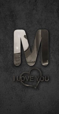 the letter m is made out of metal and has a heart on it's side