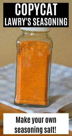 a glass jar filled with red seasoning sitting on top of a table