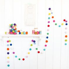 the number 25 is displayed in front of a white wall with colorful balls on it