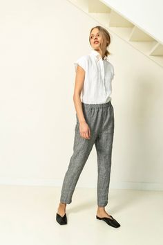 "Tapered linen pants with pockets in side seams. These linen trousers have regular fit and elastic waist. Its cuffs can be rolled up to adjust length. These trendy linen pants can be used in endless outfit combinations. Double washed for extra softness and shrinkage prevention. ABOUT US LINEN ID was born from desire to embrace things that actually matter. We aim to create sustainable garments that offer uncompromised design, are versatile and stay with You as time passes. Every LINEN ID piece is Linen Tapered Leg Pants With Pull-on Style, Casual Linen Harem Pants, Flax Pants With Elastic Waistband For Work, Linen Pants With Elastic Waistband For Work, Ankle-length Linen Harem Pants With Pockets, Casual Linen Harem Pants With Tapered Leg, Relaxed Fit Linen Pants With Elastic Waistband, Linen Trousers With Elastic Waistband, Casual Flax Workwear Pants