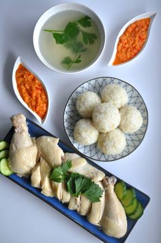 the food is prepared and ready to be eaten on the table, including chicken, cucumbers, carrots, and broccoli