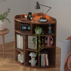 a wooden shelf with various items on it in a living room next to a couch