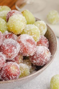 a bowl filled with powdered sugar covered fruit