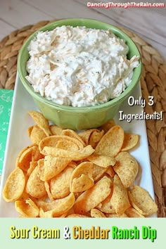 a bowl of cream cheese and chips on a plate with the words sour cream and cheddar ranch dip