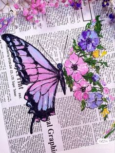 a pink butterfly sitting on top of a newspaper next to purple and yellow flower arrangements