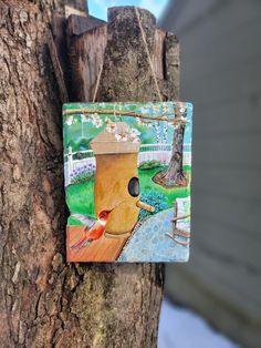 a bird house hanging on the side of a tree