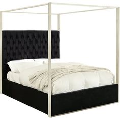 a bed with a black headboard and white sheets on it's sides, in front of a white background