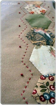 a close up view of some fabric on a table cloth with red and green designs