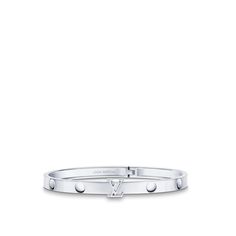 Cast in 18-kt white gold, the empreinte unisex bangle features nail-head imprints, a nod to the house’s trunk-making heritage. The lv initials motif adds a bold signature touch and also serves as a clasp for this hinged bracelet. Available in several sizes, this modern jewel can be worn solo or stacked with other pieces for an on-point look. Designer White Gold Bangle, Designer White Gold Bangle For Anniversary, Designer Engraved White Gold Bracelets, Timeless Jewelry With Palladium Hardware For Everyday Luxury, Timeless Platinum Jewelry With Palladium Hardware, Designer White Gold Bangle With Jubilee Bracelet, Luxury White Gold Engraved Cuff Bracelet, Luxury Engraved White Gold Cuff Bracelet, Timeless White Gold Jewelry With Palladium Hardware