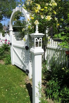 a white fence with flowers growing on it