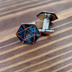 "These D20 cuff links are the perfect accessory for any stylish geek! Made from patinaed and then hand engraved copper, each pair is unique and one of a kind! Due to the patina process on the copper, the coloring and patterning is always different and beautiful. Your pair will not look exactly like the ones pictured but will have the same overall coloring and tones. Chose from two styles: Critical Hit- Both cufflinks have a 20 in the center Easy Come Easy Go: One cufflink has a 20, the other has D20 Wedding, Gamer Wedding Ideas, D&d Wedding, Dnd Wedding, Easy Come Easy Go, Gamer Wedding, Nerd Wedding, Wedding Gift Items, Nerdy Wedding