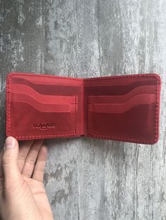 100 % full-grain handmade leather wallet. Slim and small red bifold wallet for men. Precisely made from high quality cow leather. Lasts for years, therefore is a perfect gift. The wallet is engraved with an ancient stylized grass-snake/sun sign. Wallet is made from full grain cow leather. Crazy horse is a specially processed leather type that gives it an antique appearance. This type of leather is long lasting, very durable and any scratches or rubs turn it to a different shade, bend line also f Red Leather Card Holder For Daily Use, Red Leather Card Holder With Interior Slots, Red Leather Trifold Wallet For Everyday, Red Leather Everyday Card Holder, Red Leather Wallet With Card Slots, Red Leather Trifold Wallet For Daily Use, Red Leather Card Holder With Coin Pocket, Red Bifold Card Holder, Handmade Red Wallets For Gifts