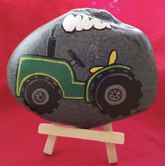 a rock with a tractor painted on it