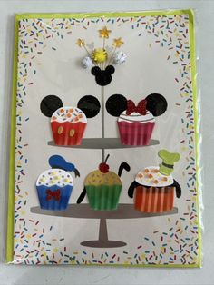 mickey mouse cupcakes are displayed on a card