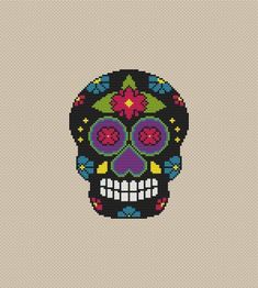 a cross stitch skull with flowers on it's head and the words cross stitch patterns written